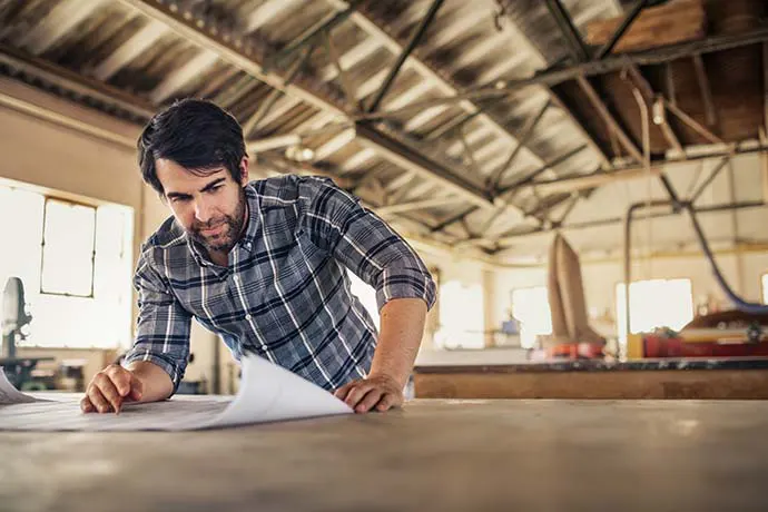 Man looking at blueprints